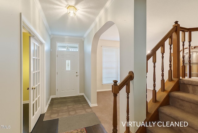 3610 Long Ridge Rd, Durham, NC 27703 - foyer entrance featuring ornamental molding, arched walkways, stairway, and carpet flooring