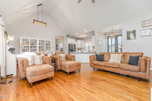 305 Maddux Dr, Pikeville, NC 27863 - living room featuring light wood-style flooring, a chandelier, high vaulted ceiling, and ceiling fan