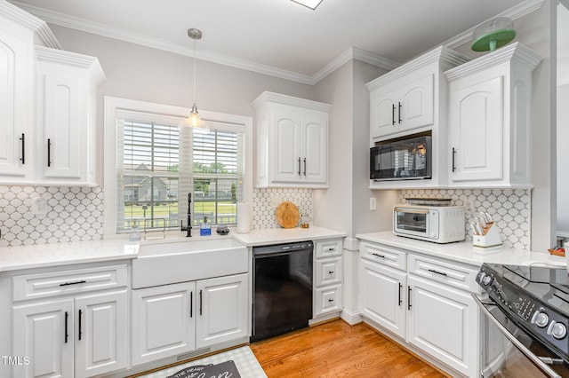 305 Maddux Dr, Pikeville, NC 27863 - kitchen with black appliances, tasteful backsplash, white cabinets, light wood-style floors, and ornamental molding