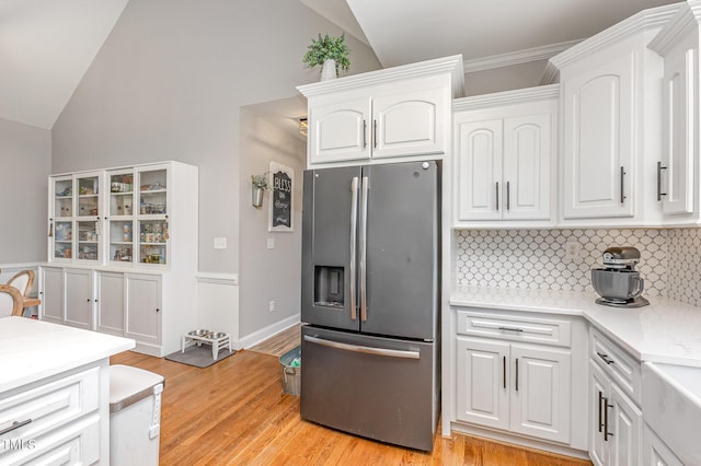 305 Maddux Dr, Pikeville, NC 27863 - kitchen featuring stainless steel refrigerator with ice dispenser, lofted ceiling, backsplash, white cabinetry, and light countertops