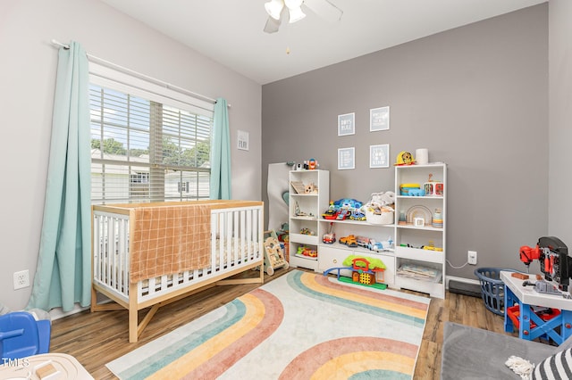 305 Maddux Dr, Pikeville, NC 27863 - bedroom with wood finished floors, a nursery area, and ceiling fan