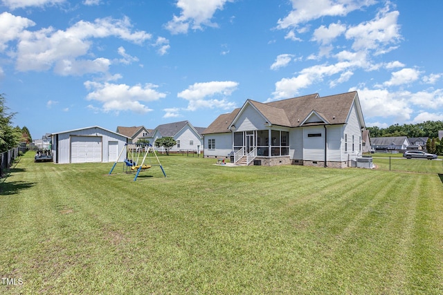 305 Maddux Dr, Pikeville, NC 27863 - fenced backyard with a sunroom, a detached garage, and an outdoor structure