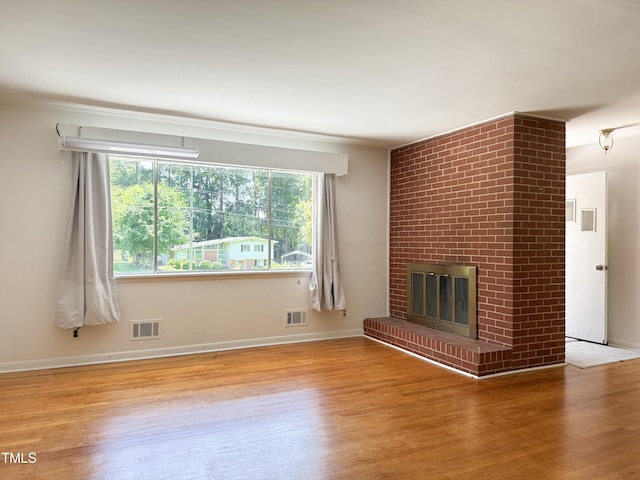 3323 Baugh St, Raleigh, NC 27604 - unfurnished living room featuring wood finished floors and a fireplace