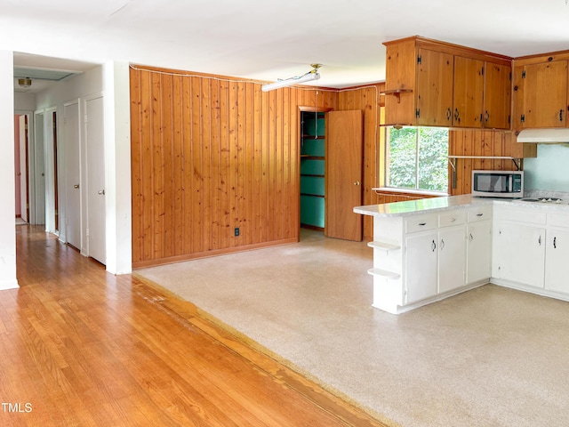 3323 Baugh St, Raleigh, NC 27604 - kitchen featuring stainless steel microwave, open shelves, light countertops, white cabinets, and under cabinet range hood