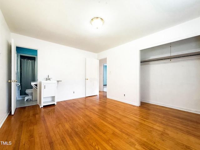 3323 Baugh St, Raleigh, NC 27604 - unfurnished bedroom featuring wood finished floors, a closet, and ensuite bath