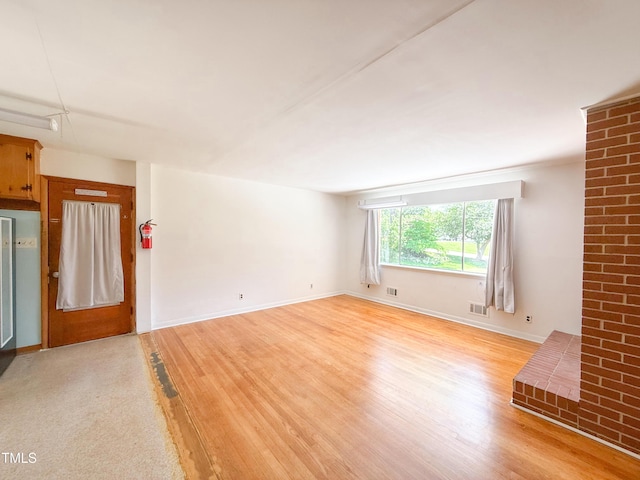 3323 Baugh St, Raleigh, NC 27604 - unfurnished living room with light wood-style floors and baseboards