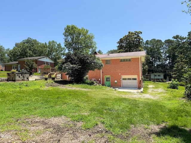 3323 Baugh St, Raleigh, NC 27604 - view of grassy yard featuring driveway and an attached garage