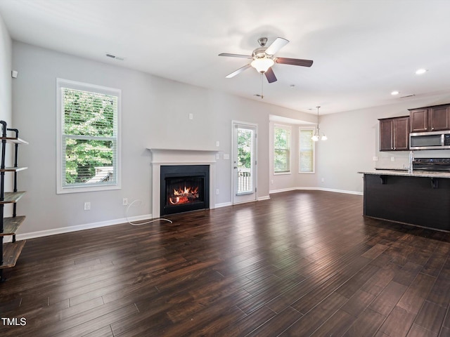115 Snowy Orchid Ln, Smithfield, NC 27577 - unfurnished living room featuring ceiling fan, recessed lighting, a lit fireplace, and dark wood-style floors
