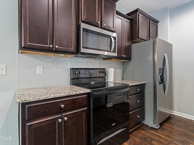 115 Snowy Orchid Ln, Smithfield, NC 27577 - kitchen featuring appliances with stainless steel finishes, dark wood-style floors, decorative backsplash, dark brown cabinets, and light stone countertops