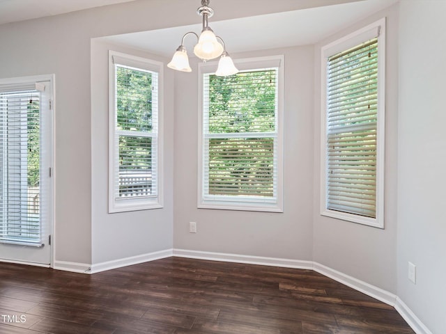115 Snowy Orchid Ln, Smithfield, NC 27577 - unfurnished dining area featuring a chandelier and dark wood-type flooring