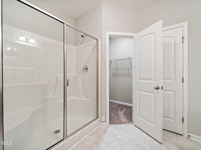 115 Snowy Orchid Ln, Smithfield, NC 27577 - bathroom featuring a shower stall, tile patterned floors, and a walk in closet