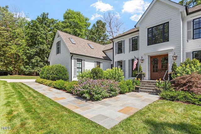 1054 Canterbury Ln, Chapel Hill, NC 27517 - view of front of house featuring french doors, a front yard, and a shingled roof