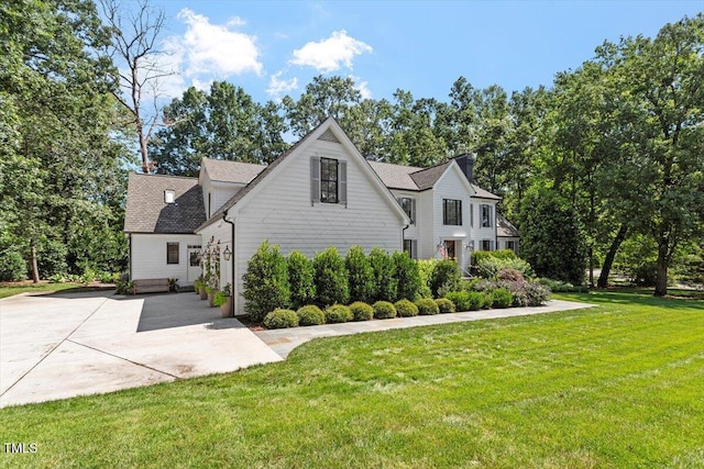 1054 Canterbury Ln, Chapel Hill, NC 27517 - view of front facade featuring a front lawn, roof with shingles, and a patio