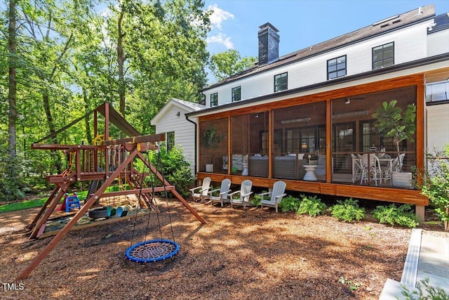 1054 Canterbury Ln, Chapel Hill, NC 27517 - rear view of property with a playground, a sunroom, and a chimney