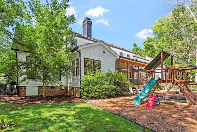 1054 Canterbury Ln, Chapel Hill, NC 27517 - rear view of property with a playground, a chimney, and a yard