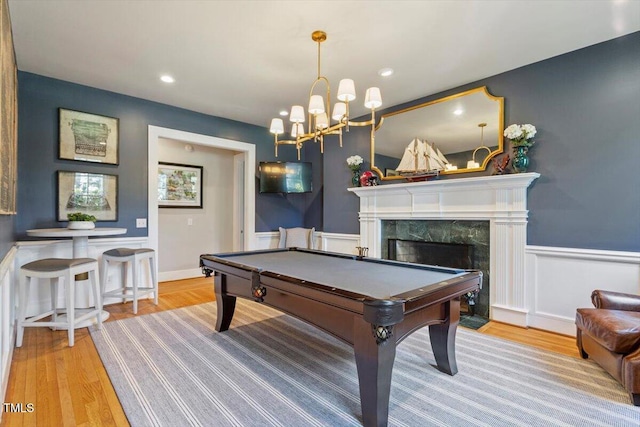 1054 Canterbury Ln, Chapel Hill, NC 27517 - recreation room featuring billiards, wood finished floors, a wainscoted wall, a fireplace, and a chandelier