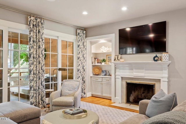 1054 Canterbury Ln, Chapel Hill, NC 27517 - living area featuring wood finished floors, a tile fireplace, and recessed lighting
