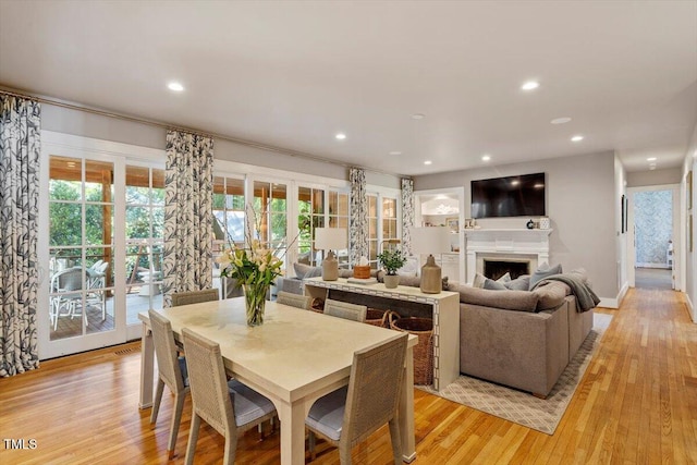 1054 Canterbury Ln, Chapel Hill, NC 27517 - dining area featuring light wood-style flooring, a fireplace, and recessed lighting