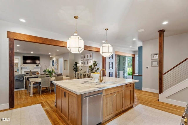 1054 Canterbury Ln, Chapel Hill, NC 27517 - kitchen featuring dishwasher, light wood-style flooring, a center island with sink, decorative light fixtures, and recessed lighting