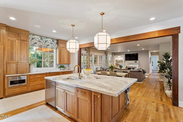 1054 Canterbury Ln, Chapel Hill, NC 27517 - kitchen with dishwasher, light wood-type flooring, an island with sink, recessed lighting, and pendant lighting