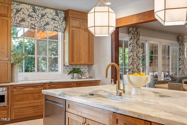 1054 Canterbury Ln, Chapel Hill, NC 27517 - kitchen with light stone countertops, decorative light fixtures, and plenty of natural light