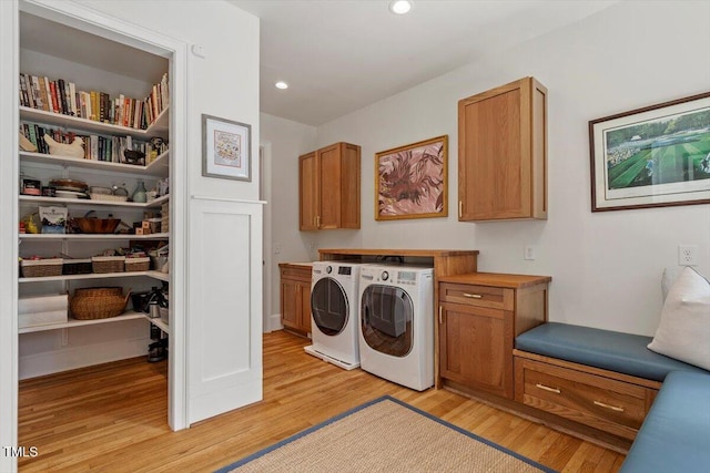 1054 Canterbury Ln, Chapel Hill, NC 27517 - washroom featuring cabinet space, light wood-type flooring, washer and clothes dryer, and recessed lighting