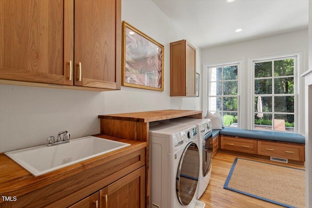 1054 Canterbury Ln, Chapel Hill, NC 27517 - laundry room featuring independent washer and dryer, cabinet space, light wood finished floors, and recessed lighting