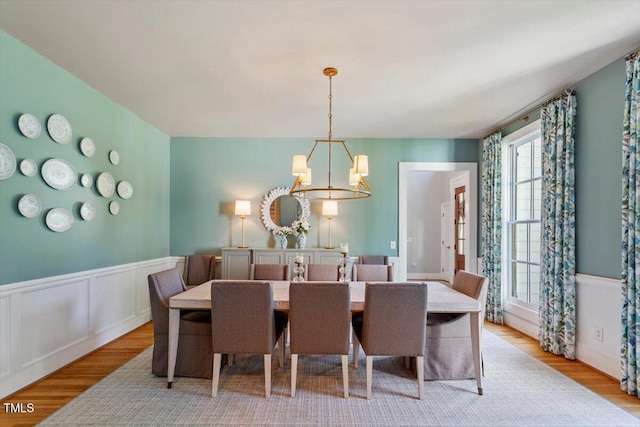 1054 Canterbury Ln, Chapel Hill, NC 27517 - dining space with light wood-style floors, a chandelier, and wainscoting