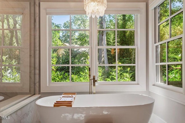 1054 Canterbury Ln, Chapel Hill, NC 27517 - bathroom with a soaking tub, a chandelier, and plenty of natural light