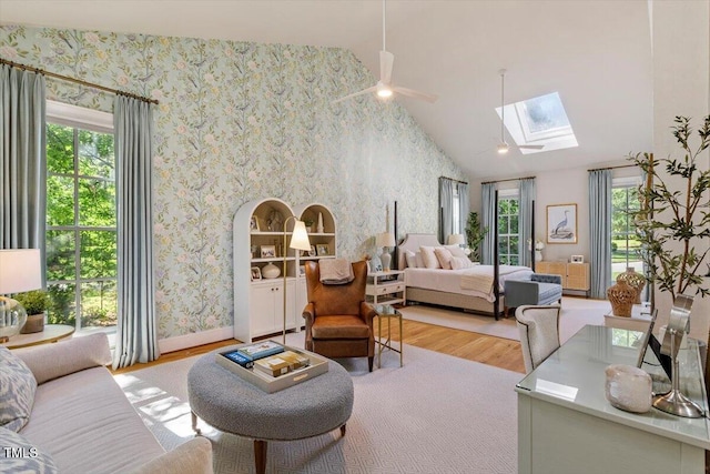 1054 Canterbury Ln, Chapel Hill, NC 27517 - bedroom featuring a skylight, wood finished floors, wallpapered walls, access to exterior, and vaulted ceiling