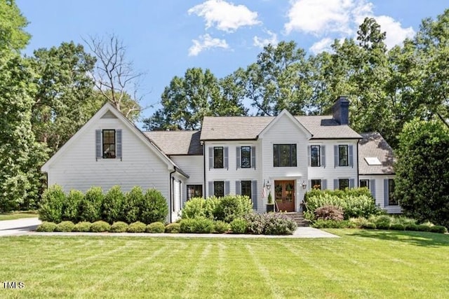 1054 Canterbury Ln, Chapel Hill, NC 27517 - view of front of house featuring a front lawn and a chimney
