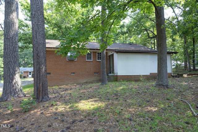 3204 Friar Tuck Rd, Raleigh, NC 27610 - back of property featuring crawl space and brick siding