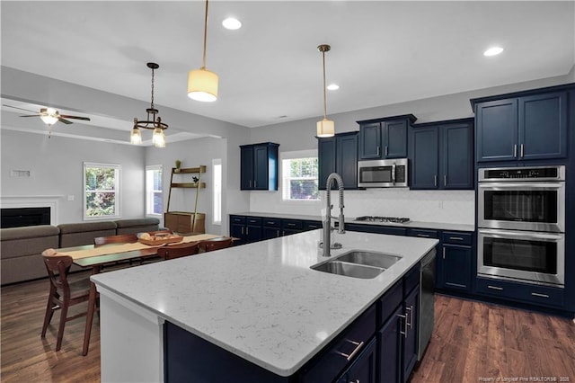 116 School Side Dr, Spring Lake, NC 28390 - kitchen featuring stainless steel appliances, ceiling fan, decorative backsplash, dark wood-type flooring, and open floor plan