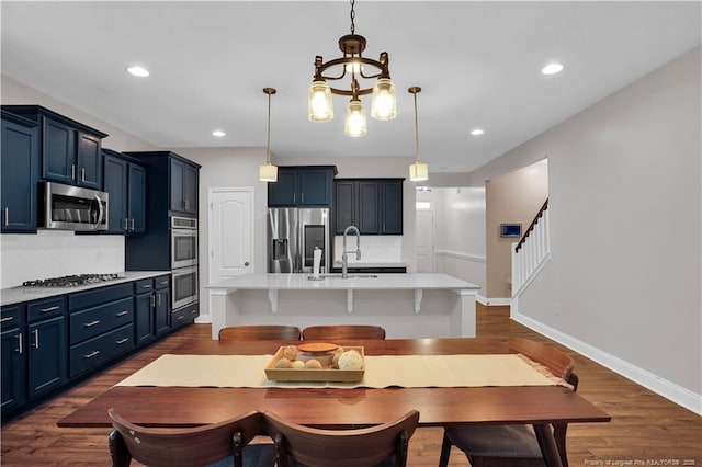 116 School Side Dr, Spring Lake, NC 28390 - dining room with dark wood finished floors, a chandelier, recessed lighting, and stairs