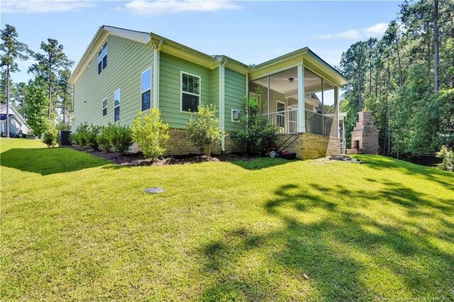 116 School Side Dr, Spring Lake, NC 28390 - view of home's exterior featuring a yard, a ceiling fan, and a sunroom