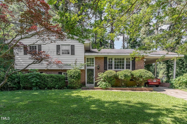612 Locust Ln, Raleigh, NC 27603 - split level home with a carport, a front lawn, concrete driveway, and brick siding