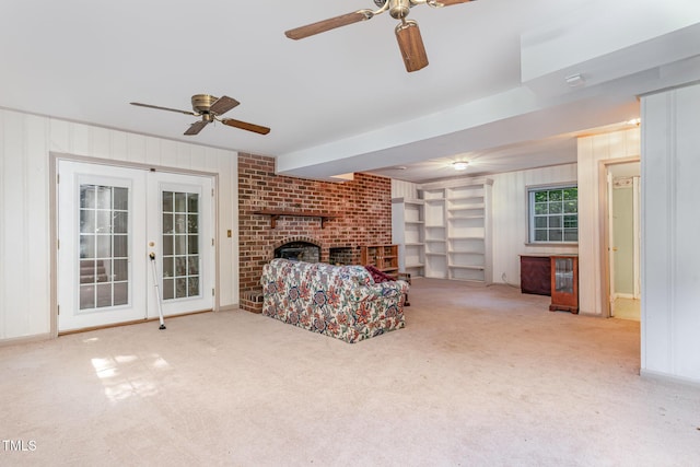 612 Locust Ln, Raleigh, NC 27603 - carpeted living room featuring ceiling fan, a fireplace, french doors, and wood walls