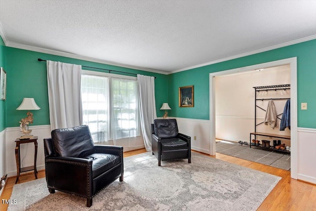 701 Bennington Dr, Raleigh, NC 27615 - living area with crown molding, wood finished floors, a textured ceiling, and wainscoting