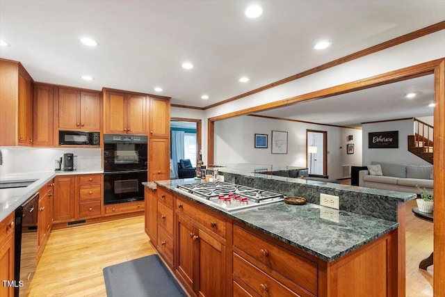 701 Bennington Dr, Raleigh, NC 27615 - kitchen featuring black appliances, ornamental molding, light wood-style floors, brown cabinets, and recessed lighting