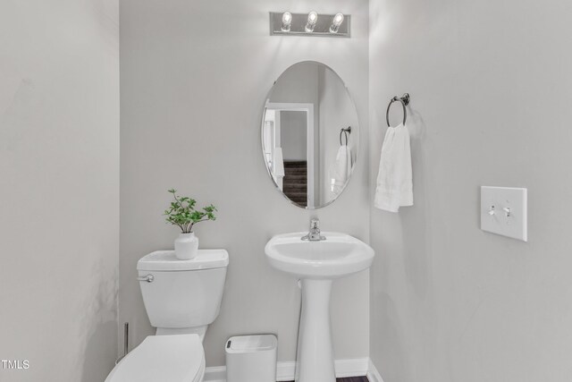 3119 Guiding Light Rd, Raleigh, NC 27610 - half bathroom featuring toilet and baseboards