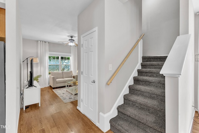 3119 Guiding Light Rd, Raleigh, NC 27610 - stairs featuring a ceiling fan and wood finished floors