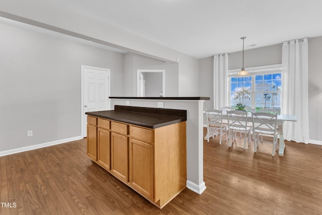 3119 Guiding Light Rd, Raleigh, NC 27610 - kitchen featuring dark countertops, dark wood-style flooring, and hanging light fixtures