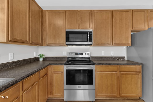 3119 Guiding Light Rd, Raleigh, NC 27610 - kitchen featuring appliances with stainless steel finishes and dark countertops