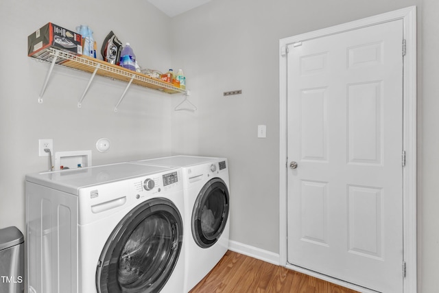 3119 Guiding Light Rd, Raleigh, NC 27610 - washroom featuring washer and clothes dryer and light wood finished floors