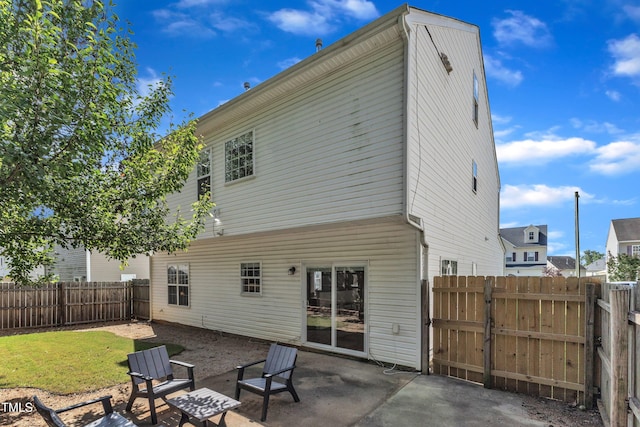 3119 Guiding Light Rd, Raleigh, NC 27610 - rear view of house featuring a fenced backyard, a patio area, and a gate