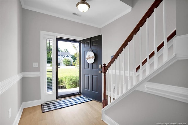 786 Century Dr, Cameron, NC 28326 - entryway with wood finished floors, stairway, and crown molding