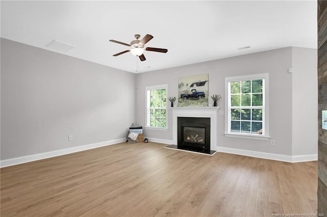 786 Century Dr, Cameron, NC 28326 - unfurnished living room with a glass covered fireplace, light wood-style flooring, and a ceiling fan