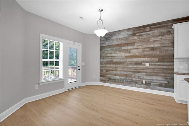 786 Century Dr, Cameron, NC 28326 - unfurnished dining area with light wood-style floors and wood walls