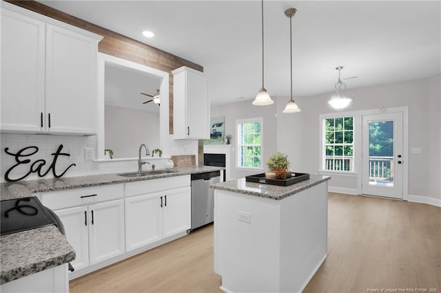 786 Century Dr, Cameron, NC 28326 - kitchen featuring stainless steel dishwasher, a kitchen island, decorative backsplash, light wood-type flooring, and ceiling fan