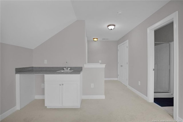 786 Century Dr, Cameron, NC 28326 - kitchen featuring light carpet, white cabinetry, vaulted ceiling, and dark countertops